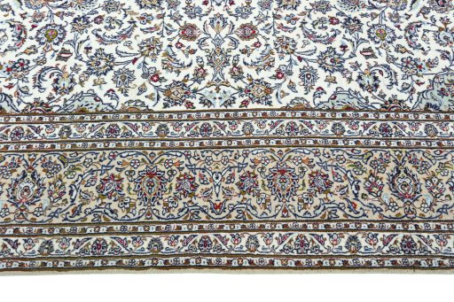 Corner detail of 2000s Kashan rug showing border pattern and Wool pile