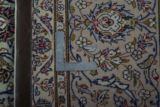 Backside of handmade 2000s Kashan rug showing knot structure and weave density