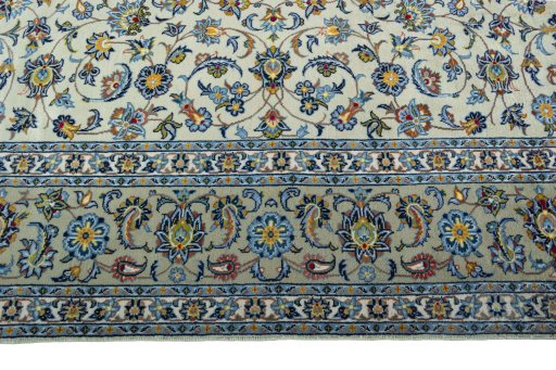 Corner detail of 2000s Kashan rug showing border pattern and Wool pile
