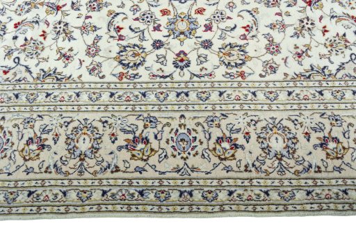 Corner detail of 2000s Kashan rug showing border pattern and Wool pile