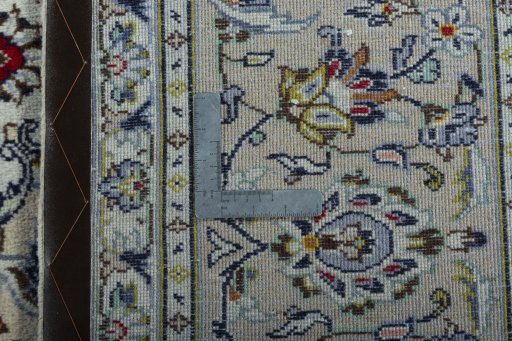 Backside of handmade 2000s Kashan rug showing knot structure and weave density