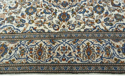 Corner detail of 2000s Kashan rug showing border pattern and Wool pile