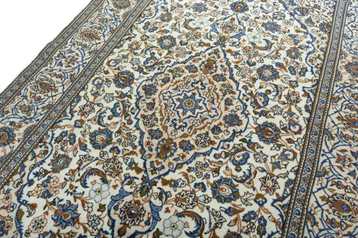 Backside of handmade 2000s Kashan rug showing knot structure and weave density