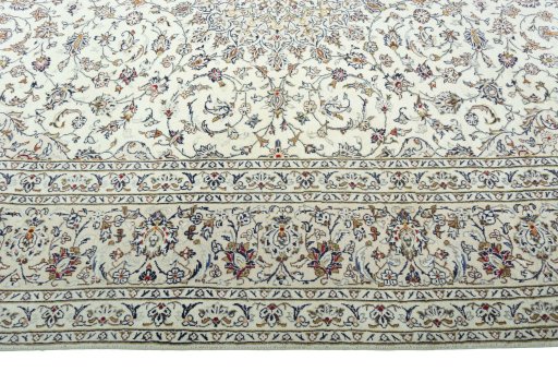Corner detail of 2000s Kashan rug showing border pattern and Wool pile