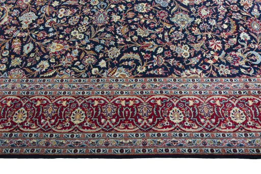 Corner detail of 2000s Kashan rug showing border pattern and Wool pile