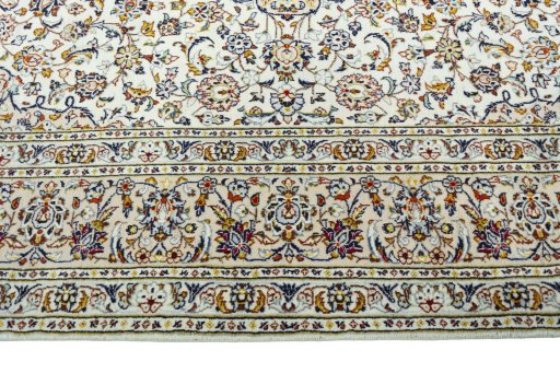 Corner detail of 2000s Kashan rug showing border pattern and Wool pile