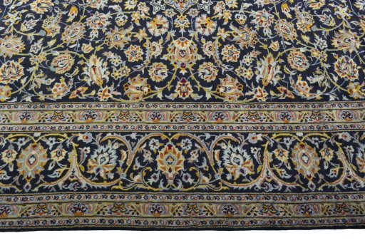 Corner detail of 2000s Kashan rug showing border pattern and Wool pile