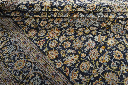 Close-up detail of 2000s Kashan rug from Iran / Persia showing Wool weave