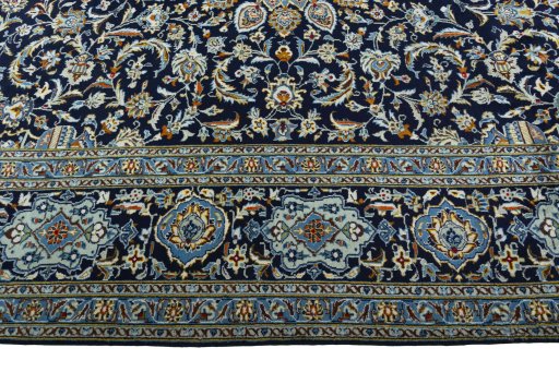 Corner detail of 2000s Kashan rug showing border pattern and Wool pile