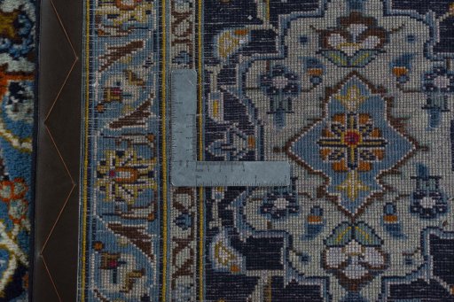 Backside of handmade 2000s Kashan rug showing knot structure and weave density