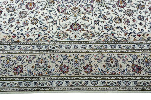 Corner detail of 2000s Kashan rug showing border pattern and Wool pile