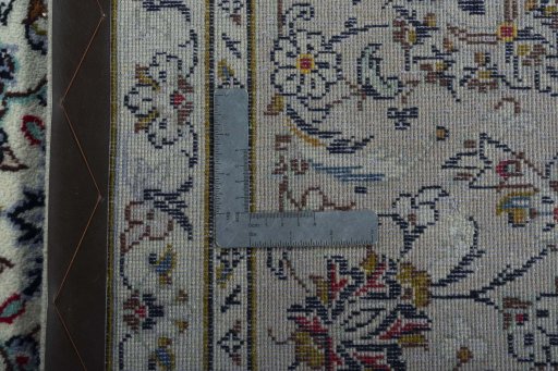 Backside of handmade 2000s Kashan rug showing knot structure and weave density