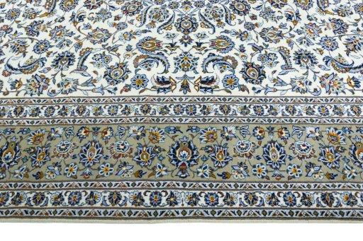 Corner detail of 2000s Kashan rug showing border pattern and Wool pile
