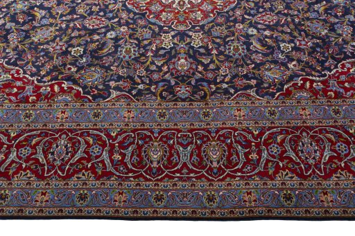 Corner detail of 2000s Kashan rug showing border pattern and Cork pile