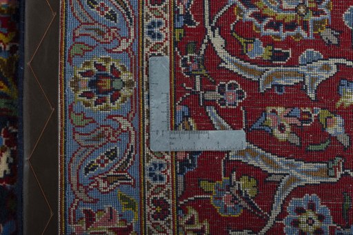 Backside of handmade 2000s Kashan rug showing knot structure and weave density