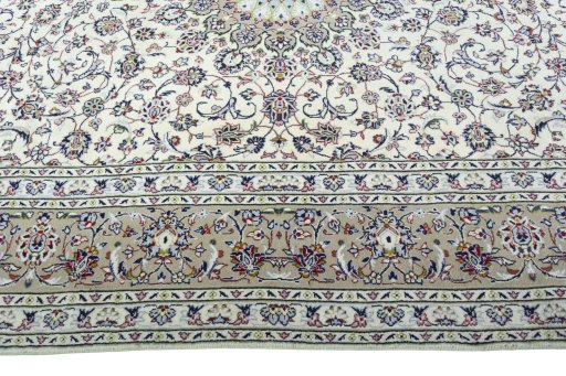 Corner detail of 2000s Kashan rug showing border pattern and Wool pile