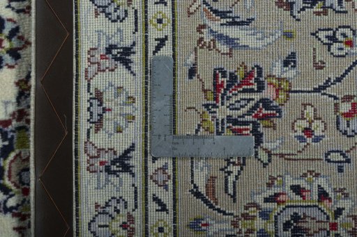 Backside of handmade 2000s Kashan rug showing knot structure and weave density