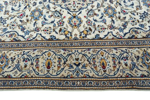 Corner detail of 2000s Kashan rug showing border pattern and Wool pile