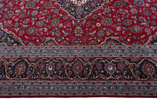 Corner detail of 2000s Kashan rug showing border pattern and Wool pile