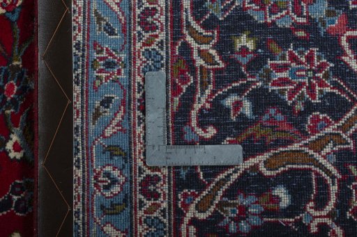 Backside of handmade 2000s Kashan rug showing knot structure and weave density