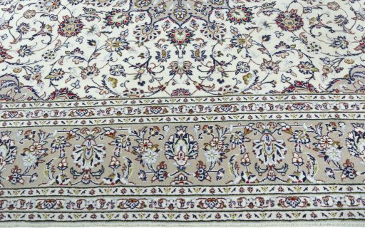 Corner detail of 2000s Kashan rug showing border pattern and Wool pile