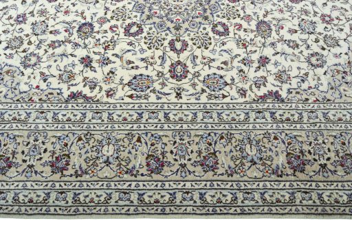 Corner detail of 2000s Kashan rug showing border pattern and Wool pile