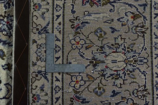 Backside of handmade 2000s Kashan rug showing knot structure and weave density