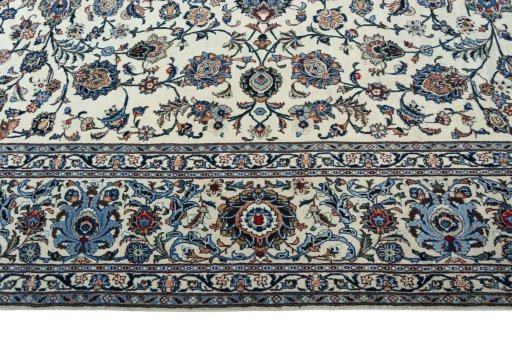 Corner detail of 2000s Kashan rug showing border pattern and Wool pile