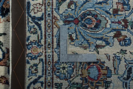 Backside of handmade 2000s Kashan rug showing knot structure and weave density