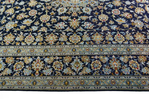 Corner detail of 2000s Kashan rug showing border pattern and Wool pile