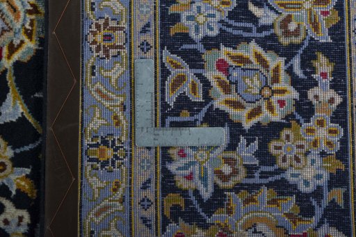 Backside of handmade 2000s Kashan rug showing knot structure and weave density