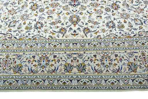 Corner detail of 2000s Kashan rug showing border pattern and Wool pile