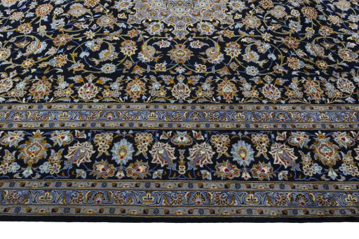 Corner detail of 2000s Kashan rug showing border pattern and Wool pile