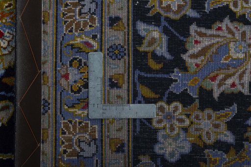 Backside of handmade 2000s Kashan rug showing knot structure and weave density