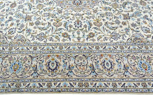 Corner detail of 2000s Kashan rug showing border pattern and Wool pile