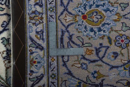 Backside of handmade 2000s Kashan rug showing knot structure and weave density