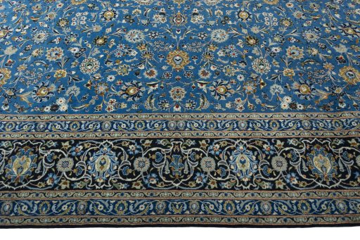 Corner detail of 2000s Kashan rug showing border pattern and Wool pile