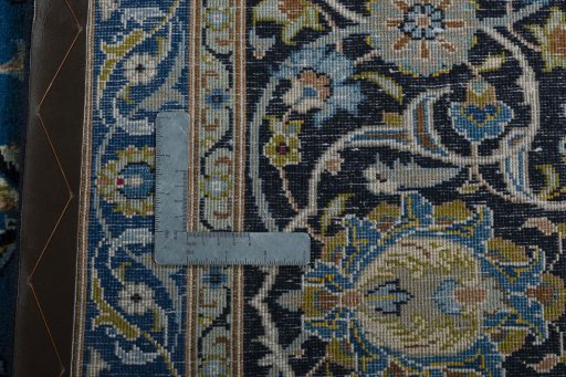Backside of handmade 2000s Kashan rug showing knot structure and weave density