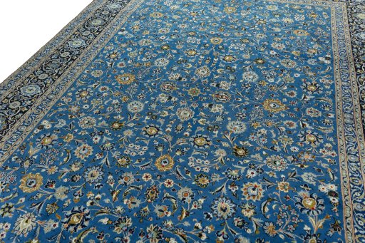 Backside of handmade 2000s Kashan rug showing knot structure and weave density