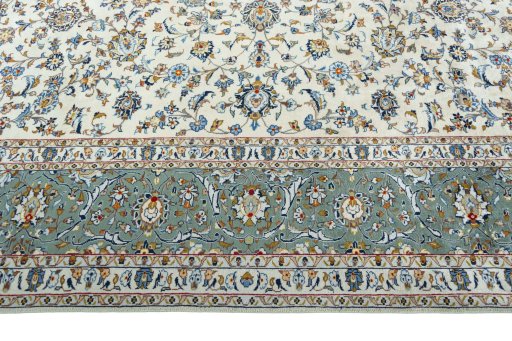 Corner detail of 2000s Kashan rug showing border pattern and Wool pile