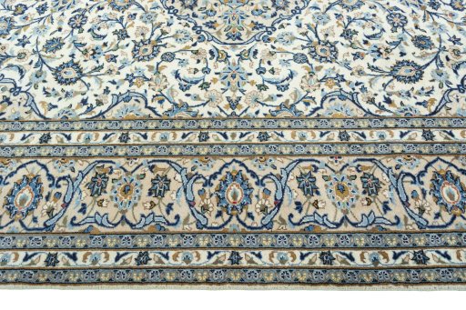 Corner detail of 2000s Kashan rug showing border pattern and Wool pile