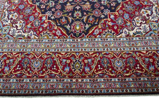 Corner detail of 2000s Kashan rug showing border pattern and Wool pile