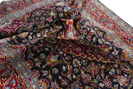 Backside of handmade 2000s Kashan rug showing knot structure and weave density