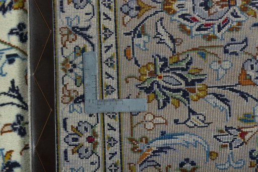 Backside of handmade 2000s Kashan rug showing knot structure and weave density
