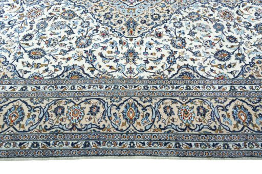 Corner detail of 2000s Kashan rug showing border pattern and Wool pile