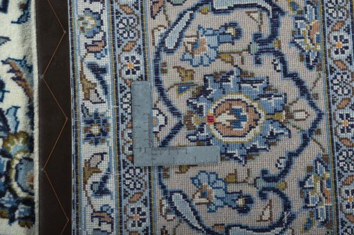 Backside of handmade 2000s Kashan rug showing knot structure and weave density