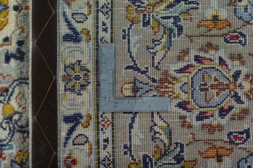 Backside of handmade 2000s Kashan rug showing knot structure and weave density