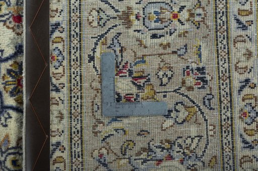 Backside of handmade 2000s Kashan rug showing knot structure and weave density