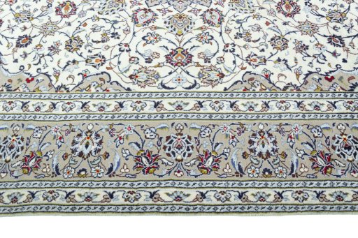 Corner detail of 2000s Kashan rug showing border pattern and Wool pile