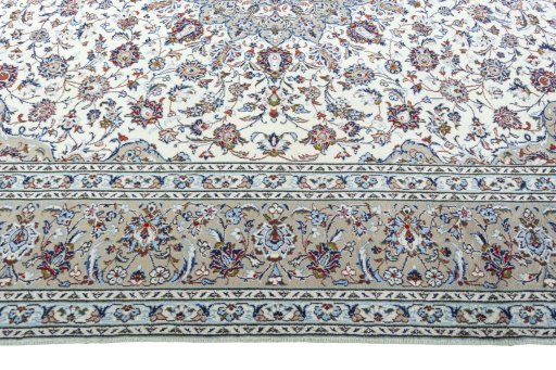 Corner detail of 2000s Kashan rug showing border pattern and Wool pile